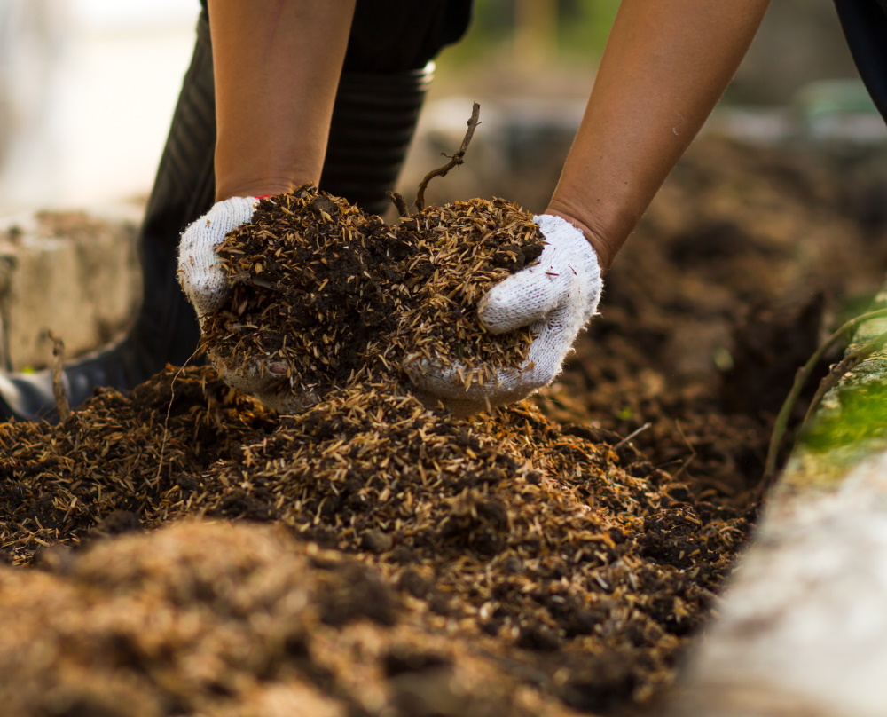 Adding compost to the garden bed | The Coeur d Alene Coop