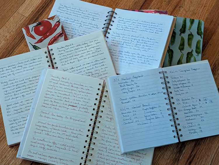 stack of garden journals open on a table